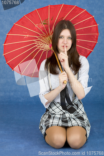 Image of Girl with a red umbrella on blue background