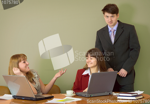Image of Girls at a desktop and their boss
