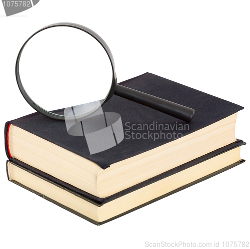 Image of Still-life from a magnifier and a pile of old books