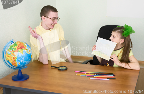 Image of Girl shows new drawing to the brother