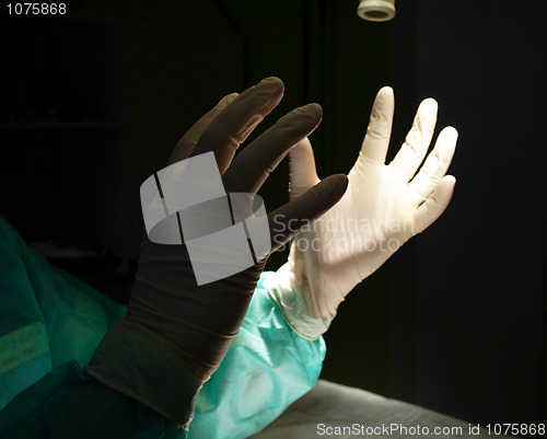 Image of Surgeon holding up hands in protective gloves