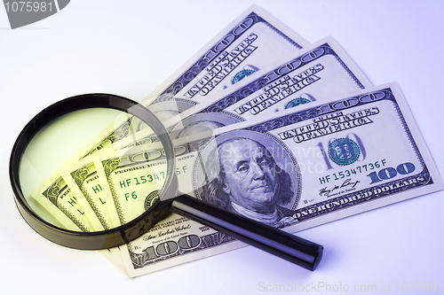 Image of Dollars under a magnifying glass