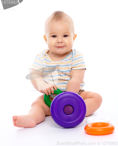 Image of Little boy play with toys