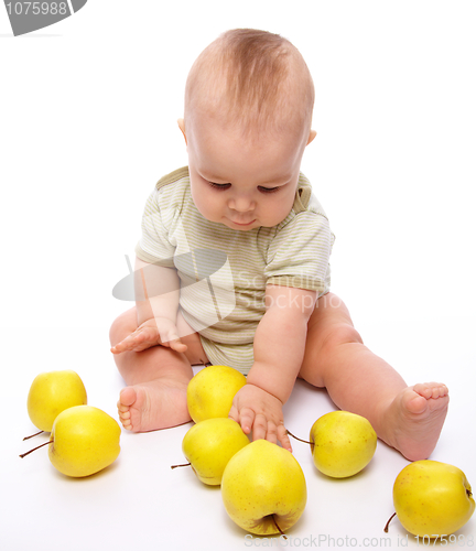 Image of Little boy play with apples