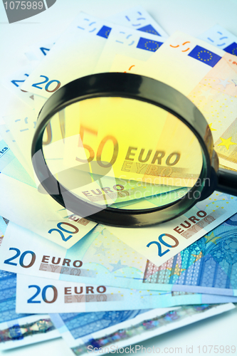 Image of Euro currency under a magnifying glass