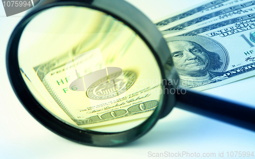 Image of Dollars under a magnifying glass