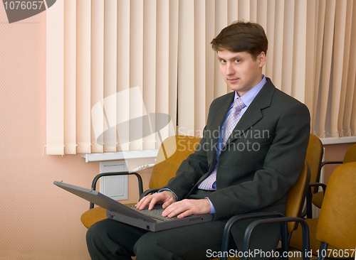 Image of Person in a suit with the laptop