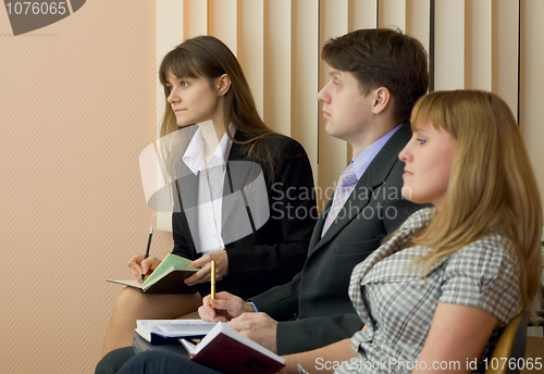 Image of Group of businessmen sitting on armchairs