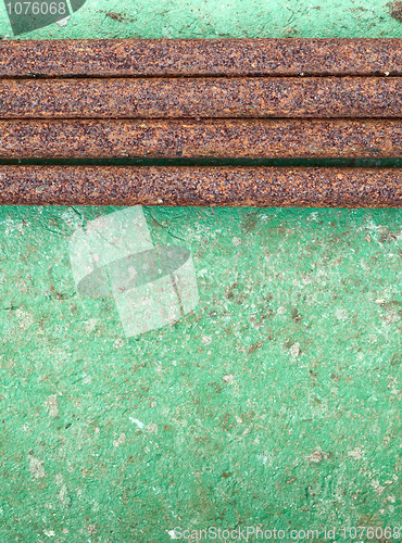 Image of Old concrete painted wall with rusty pipes