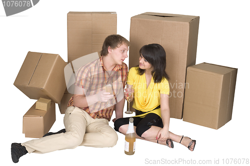 Image of Girl and the guy drink champagne near boxes