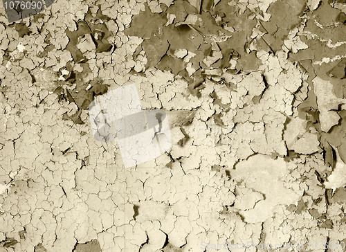 Image of old damaged paint on a concrete wall - sepia