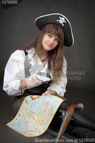 Image of Pirate girl with sea map sit on a black