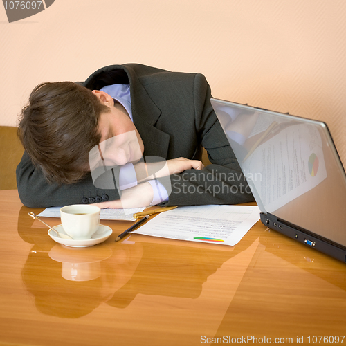 Image of Businessman has fallen asleep sitting at meeting