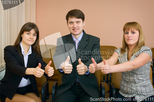 Image of Team of businessmen show thumb up
