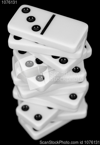 Image of Pile from dominoes on black background