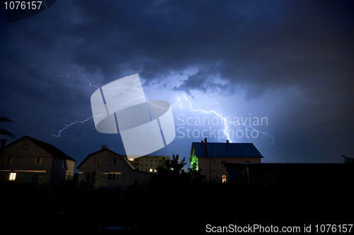 Image of Lightning in the cloudy sky over village