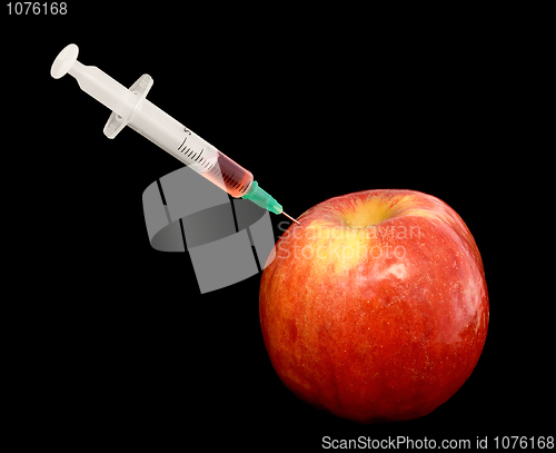 Image of Red apple with syringe on black