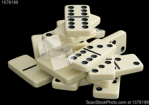 Image of Heap of dominoes on a black background