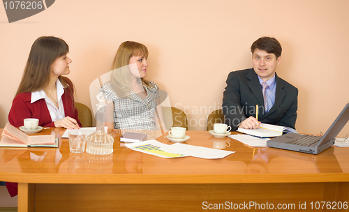 Image of Business team sits at the table