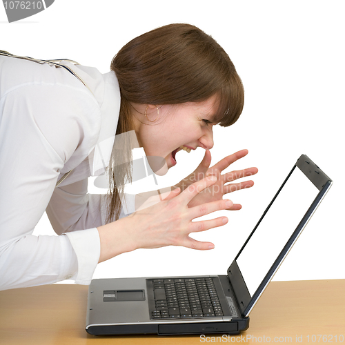 Image of Girl emotionally shouts at the laptop