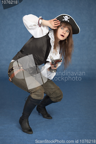 Image of Frightened pirate girl - with pistol on a blue