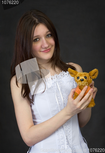 Image of Teenager hold a toy - the doggie