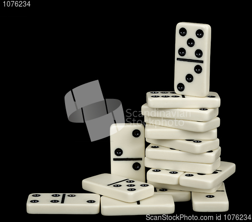 Image of Heap of white dominoes isolated on black
