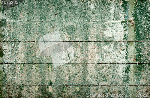 Image of Green messy surface of the old wall covered with boards