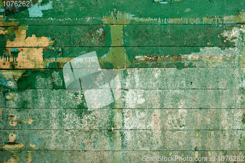 Image of Green surface of the old wall covered with boards