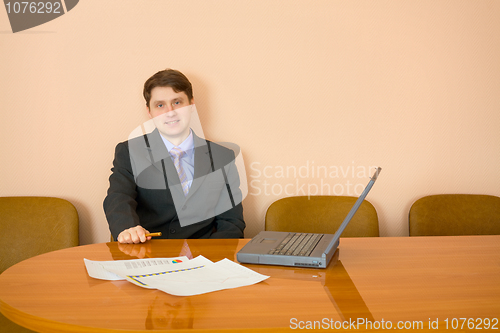 Image of Businessman at a table with laptop