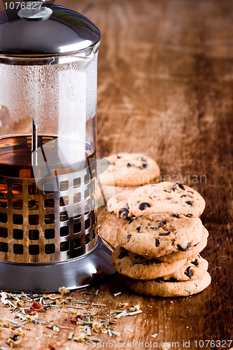 Image of french press with hot tea and fresh baked cookies