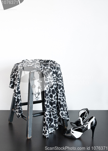 Image of Fashionable dress on old wooden stool