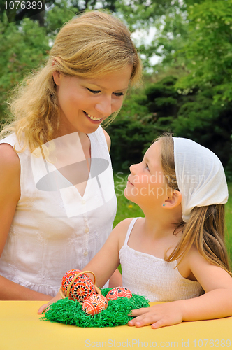 Image of Young mother and daughter having Easter time