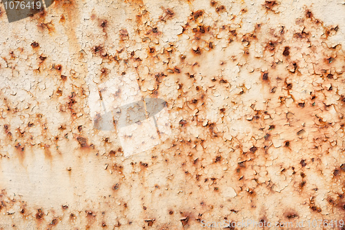 Image of Rusty iron sheet with the peeled paint and corrosion stains
