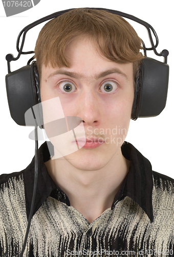 Image of Amusing young man in ear-phones with protruding eyes