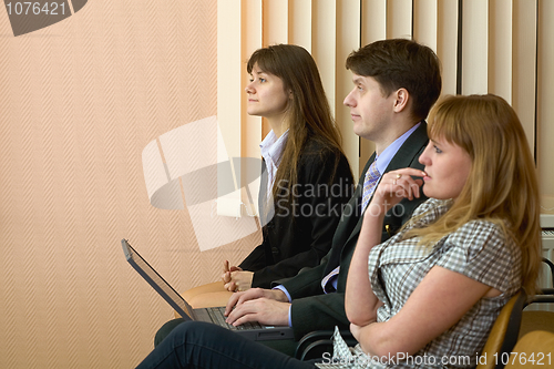 Image of Group of businessmen sitting on armchairs