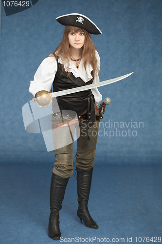 Image of Sexyl woman - pirate armed with a sabre on blue background