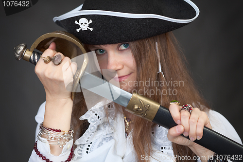 Image of Girl in pirate hat with a sabre in hands