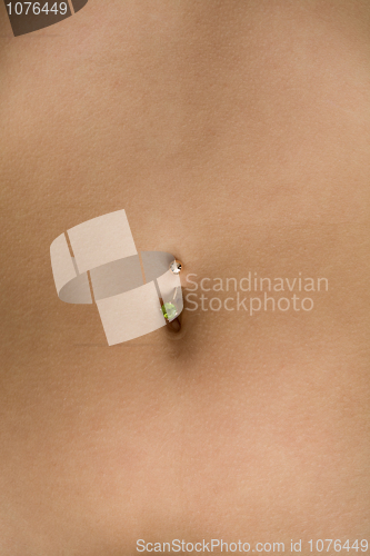 Image of Female tummy with a navel and piercing