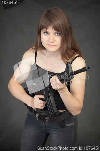 Image of Beautiful young sexual woman - soldier with a rifle