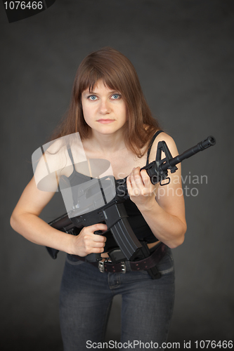 Image of The beautiful young sexual woman with a rifle