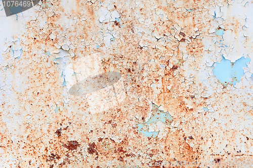 Image of Weathered surface of a steel sheet with paint scraps