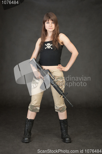 Image of Young terrible woman in trousers and boots up in arms