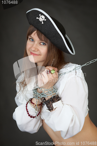 Image of Young sexy girl in a costume pirate chained in a chain