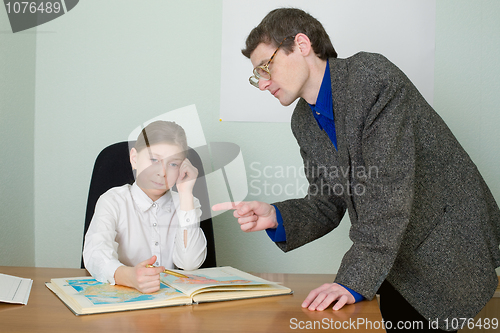 Image of Tutor and schoolgirl with atlas