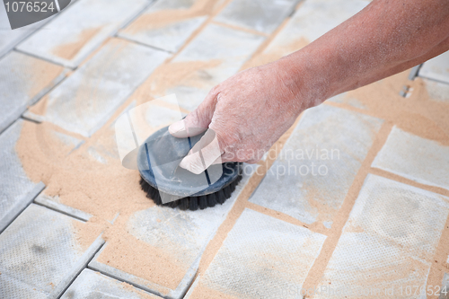 Image of Installation of brick platform - smoothing-out with sand