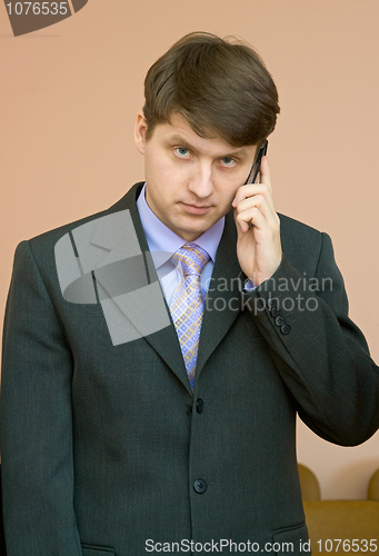 Image of Man speaks by a mobile phone