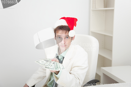 Image of Guy in Christmas hat gives us money