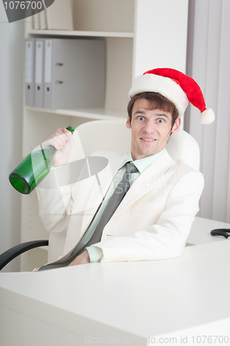 Image of Businessman begins Christmas celebrating at office on workplace