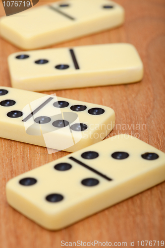 Image of Bones of dominoes on wooden background close up